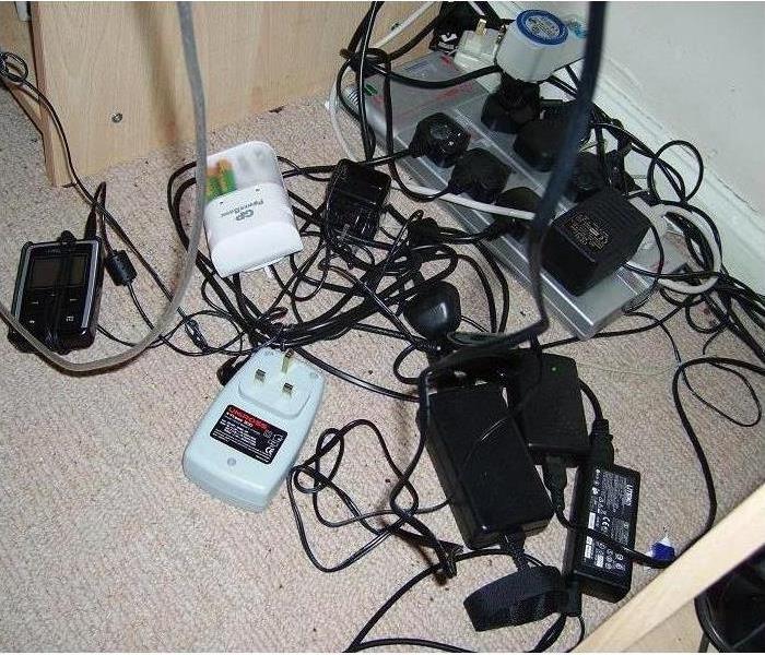 A bunch of cords plugged into an outlet. 